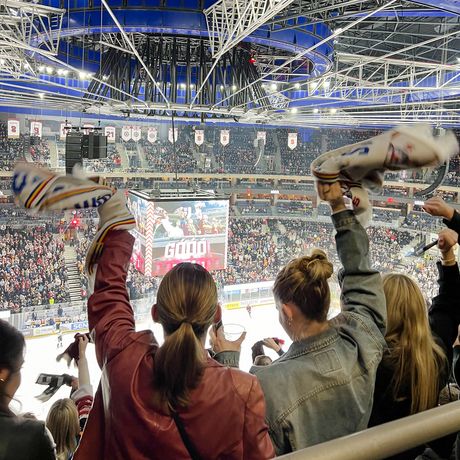 prague two girls cheering at a hockey game