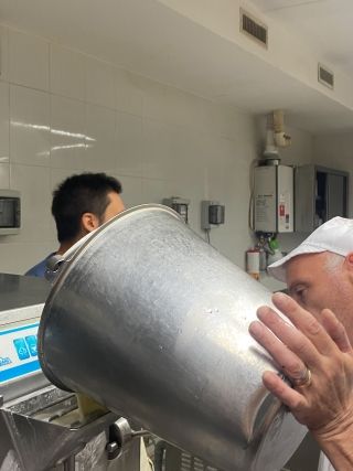 Pouring the mixture into the gelato machine.
