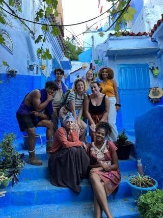 Students posing on blue staircase in Morocco