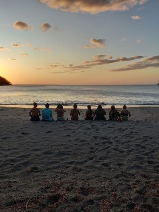 Students enjoying the sunset on a beach