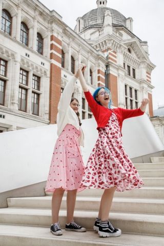 High school girls twirling on stairs in London