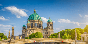 Berlin Cathedral with boat going under bridge.