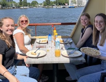 amsterdam netherlands students eating on boat