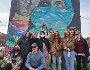 Students standing in front of an art wall in Santiago, Chile