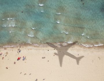 airplane shadow on beach abroad
