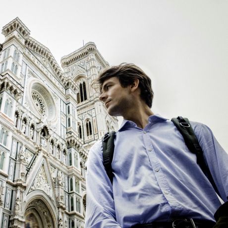 Florence man with backpack in front of cathedral