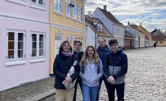 High school students posing on cobbled street in Denmark