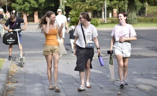 High school girls walking through a park in Seville