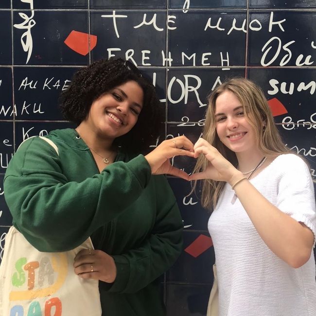 Students posing in front of I Love You Wall in Montmartre