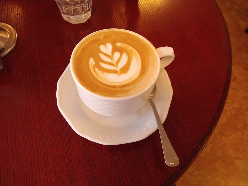 Photo of a cappuccino with a design on top.