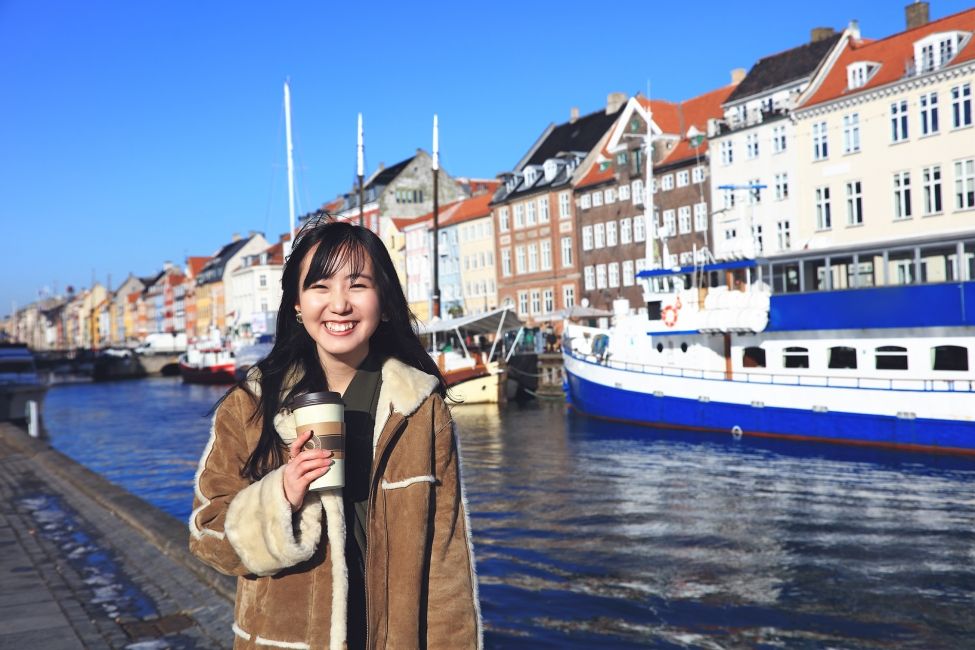Copenhagen girl with coffee by river