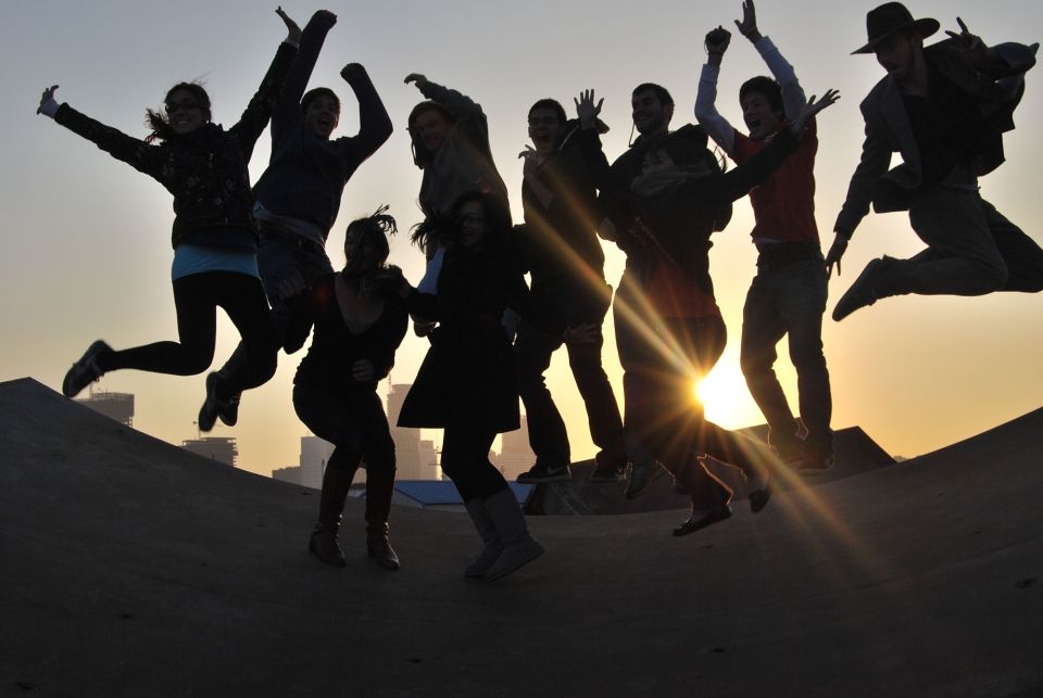 Students jumping in the air at sunset