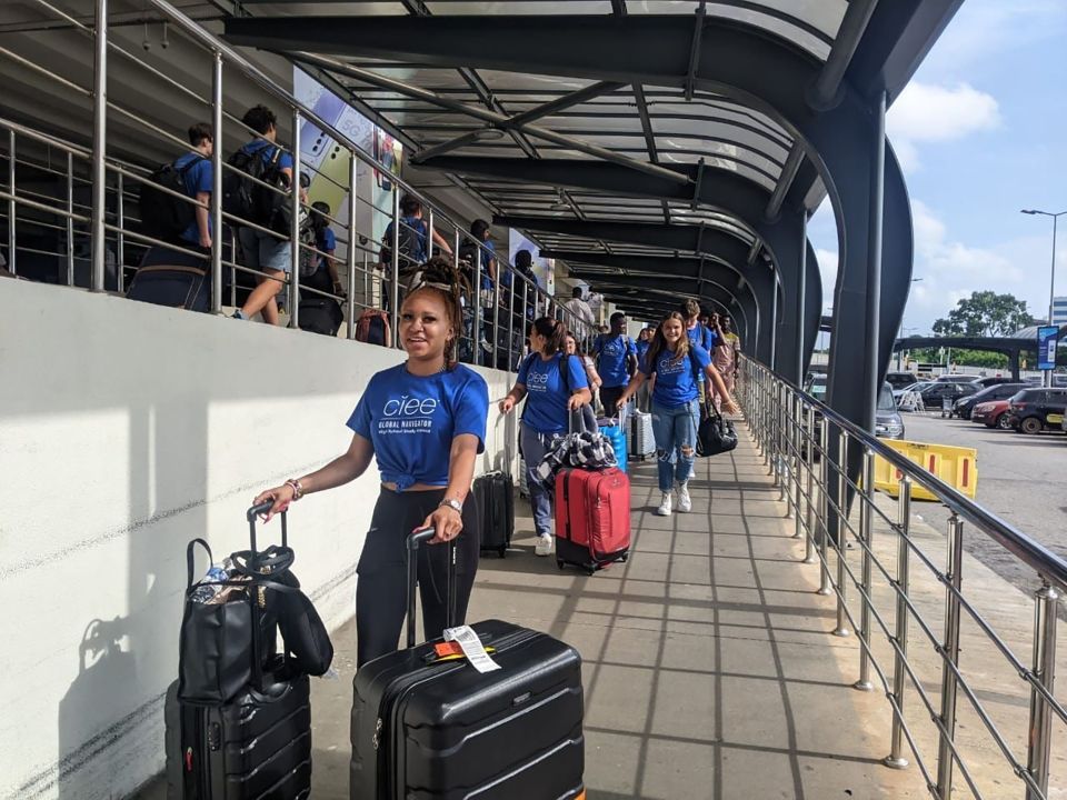 High school students arriving at the airport with their suitcases