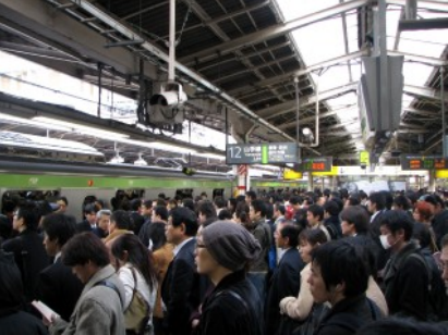 Squashed with a stranger: The daily commute in a Tokyo train car.