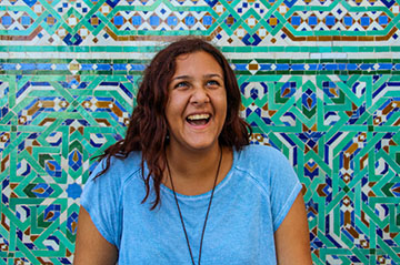 HSSA student in Rabat laughing in front of mosiac wall