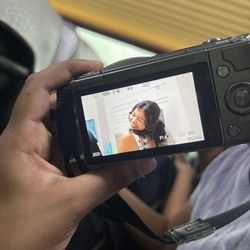 Student smiling through a camera