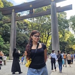 Girl standing in front of landmark in Japan surrounded by others