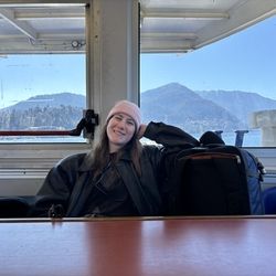 A profile photo of Kayleigh leaning on her travel backpack.