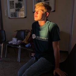 Young boy wearing "Experiment Exchange" t-shirt