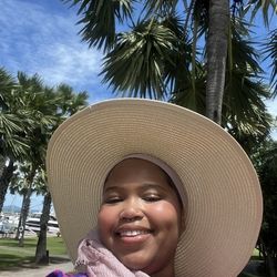 Ciani smiling in a sun hat in Pattaya, Thailand