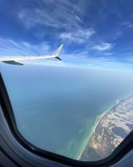 Shot of an airplane's wing out of a plane window