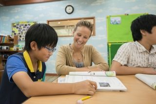 Teach in South Korea teacher with students in classroom