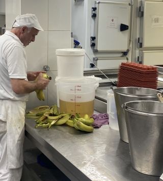 Gelato maker peeling the bananas.