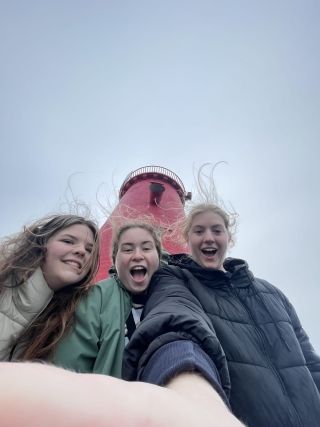 Students posing in front of lighthouse in Dublin