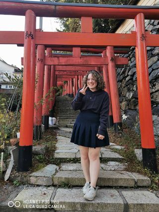 High school exchange student posing in front of Japanese temple