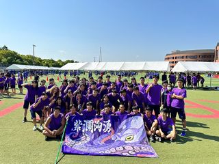 Students in purple uniforms posing for a sports team photo