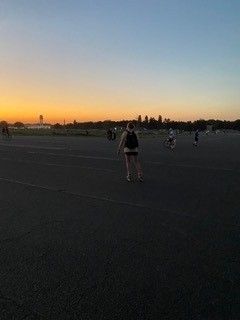 Students watching sunrise on beach