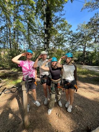 Teen participants wearing hats before going on a summer adventure abroad