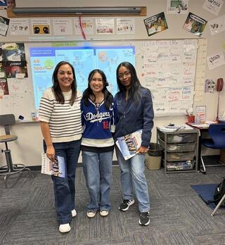 Study abroad high school students in classroom helping on program