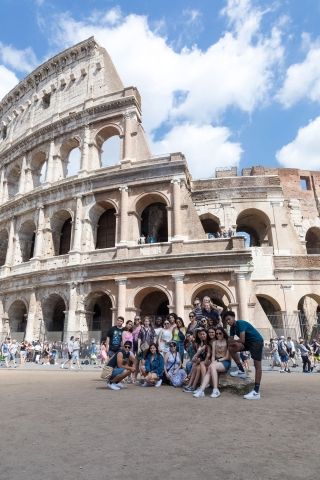 High school students posing in front of Colosseum in Rome