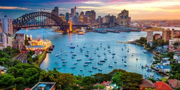 sydney harbor full of boats at sunset