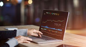 Specialist looking at stocks on a laptop