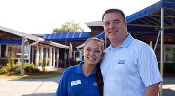 young employee with boss amusement park