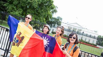 employees with flags by white house
