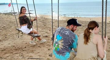 students swing on beach abroad singapore
