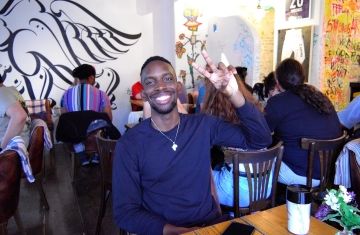 kyoto summer student in restaurant peace sign