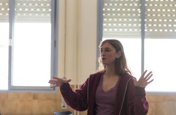 Teacher gesturing with her hands while teaching class