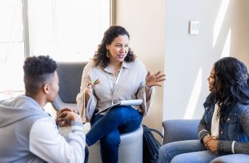 high school counselor meeting with two students