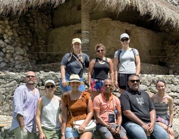 Photo of 9 people in front of ruins