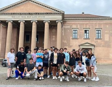 High school students posing in front of columned building
