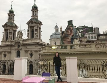 A rooftop patio with church spires in the background