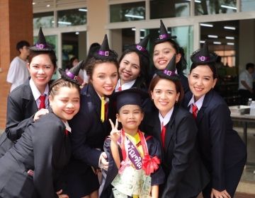 7 people pose for a picture in witch outfits for a graduation ceremony