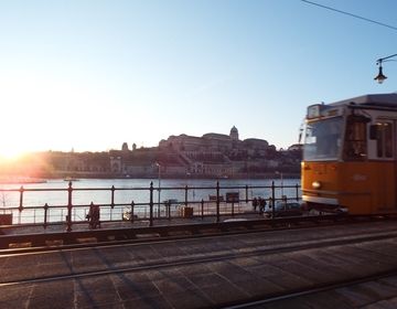 Tram passing in front of Danube River