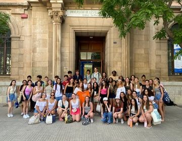 group photo of students in front of campus