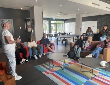 Students listen to Glenn Gannon talk about his experience. 