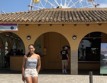 girl in front of farris wheel